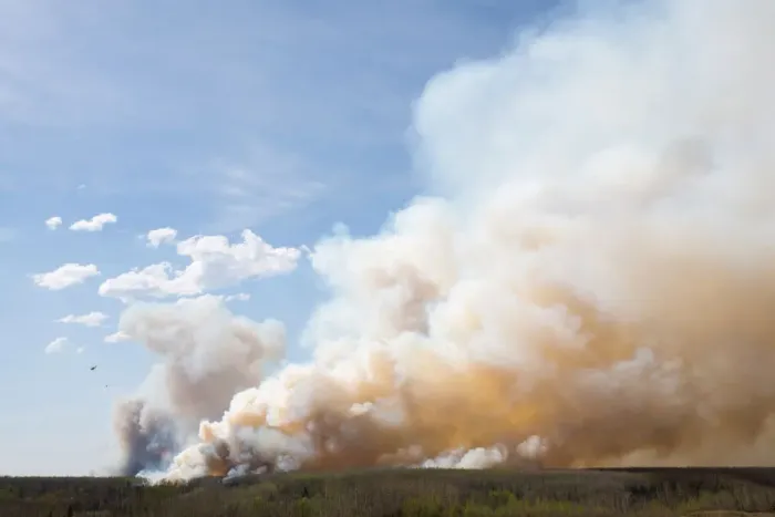 Framed Print : A helicopter flies past thick smoke while battling a major forest fire outside of Fort Framed Print : A helicopter flies past thick smoke while battling a major forest fire outside of Fort