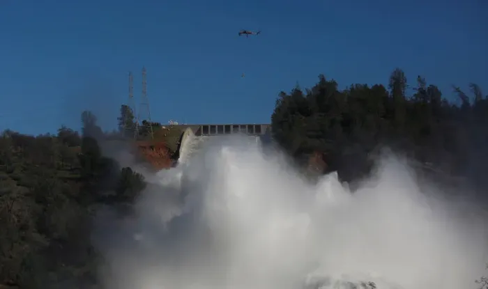 Framed Print : Helicopters carry rocks as water is released from the Lake Oroville Dam after an Framed Print : Helicopters carry rocks as water is released from the Lake Oroville Dam after an