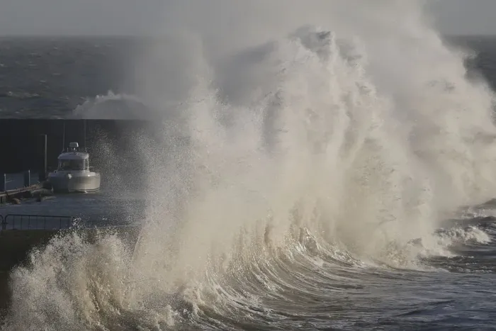 Framed Print : A high wave crashes on the protecting wall at the fishing harbour in Pornic