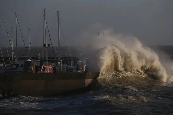 Framed Print : A high wave crashes on the protecting wall at the fishing harbour in Pornic