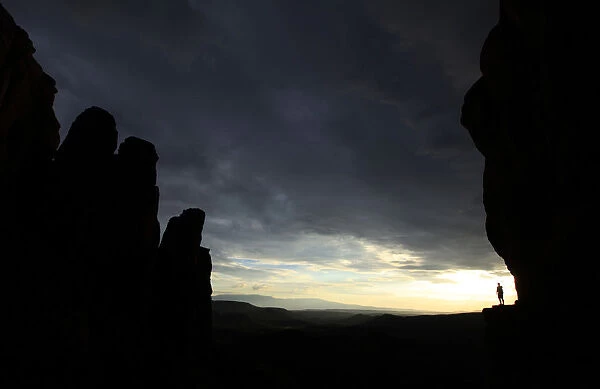 Hiker rounds Cathedral Rock at sun set in Sedona, Arizona