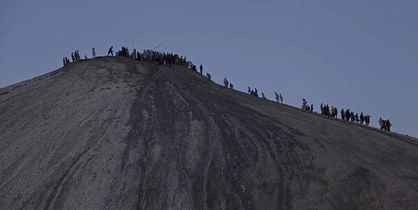 Hindu devotees climb towards the crater of the Chandargup mud volcano in Pakistan s