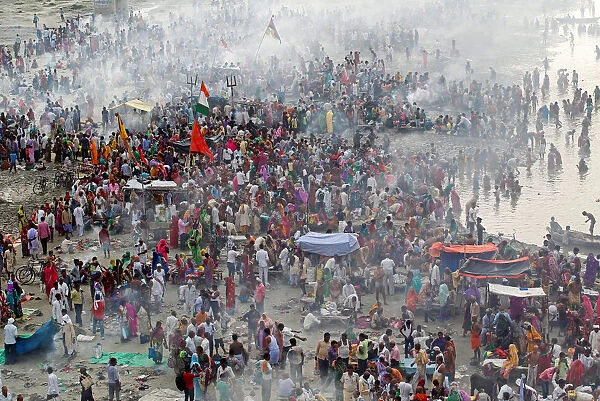 Hindu devotees gather to perform prayers on the banks of the river Ganga on the occasion