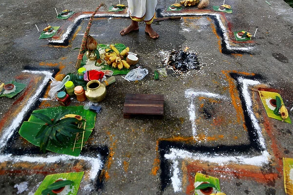 A Hindu man prays for his mother, who died 16 days ago, at a river side in Yangon