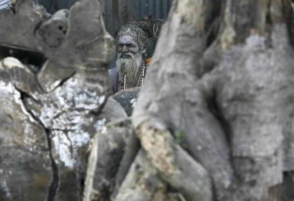 A Hindu monk rests in his makeshift shelter in Kolkata