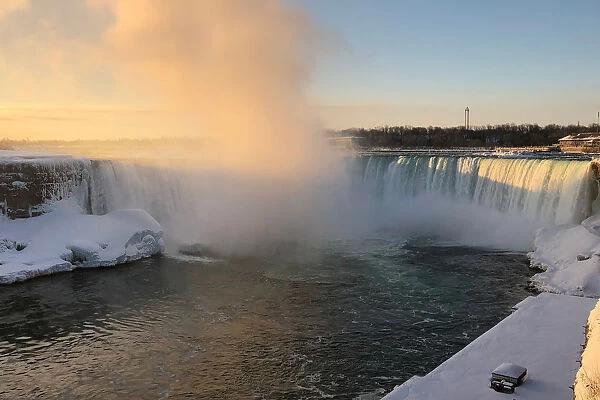 The Horseshoe Falls in Niagara Falls is lit by morning sun as viewed from the Canadian