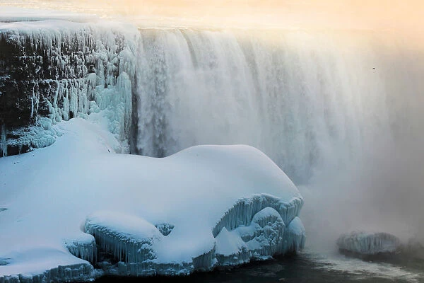 The Horseshoe Falls in Niagara Falls is lit by morning sun as viewed from the Canadian