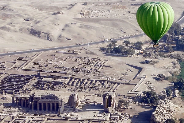 A hot-air balloon flies near Ramesseum temple on the west bank of Luxor