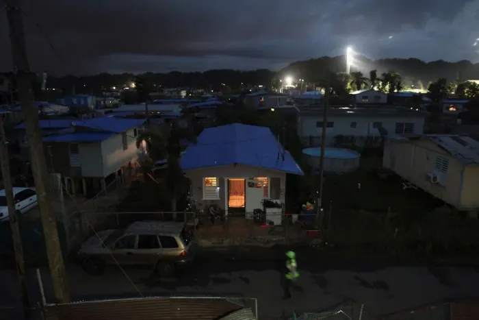 Framed Print : A house is lit up with the help of a generator next to houses in the dark after Hurricane Framed Print : A house is lit up with the help of a generator next to houses in the dark after Hurricane
