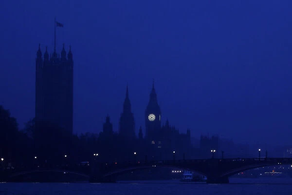 The Houses of Parliament are seen in early morning mist in central London