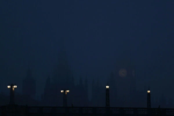 The Houses of Parliament are seen in late afternoon mist in central London