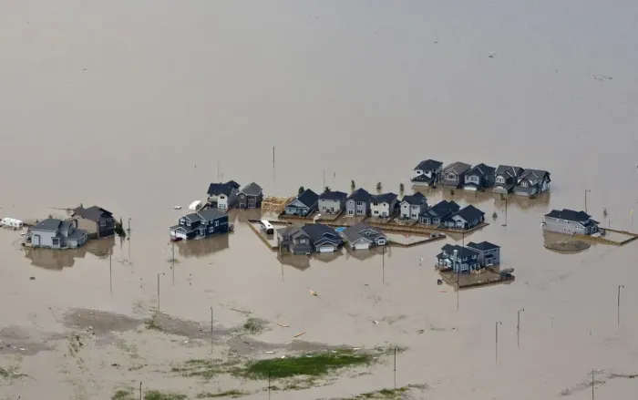 Framed Print : Houses are surrounded by flood water in High River