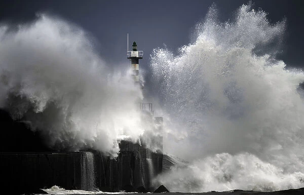 Huge waves crash on the San Esteban de Pravia seafront in the northern Spanish region of