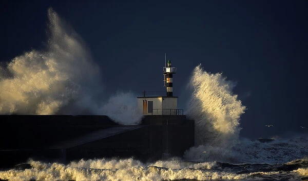 Huge waves crash on the San Esteban de Pravia seafront in the northern Spanish region of
