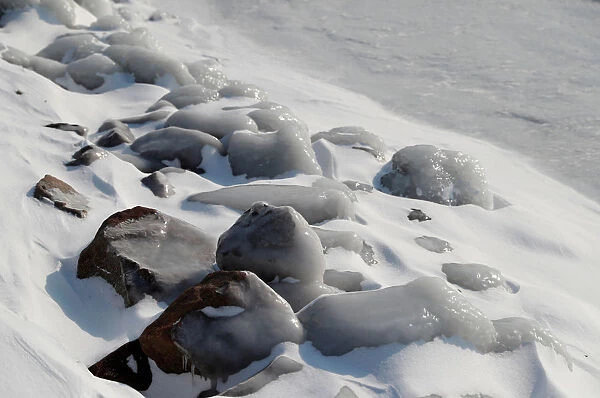 Ice covered stones are seen during a winter day on the shore of Lake Balaton in Fonyod