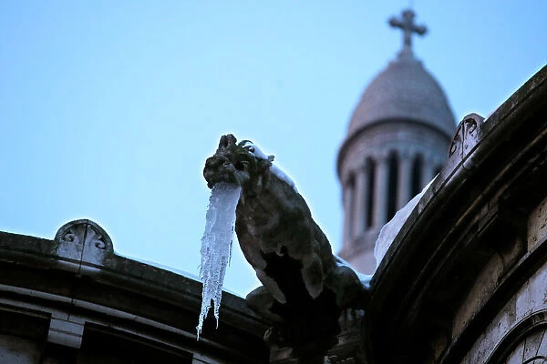 Icicles hang from a gargoyle on the Sacre Coeur basilica at the Butte Montmartre in Paris