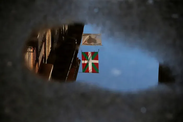 Framed Print : An Ikurrina and a banner that reads, Basque Prisoners to Basque Country