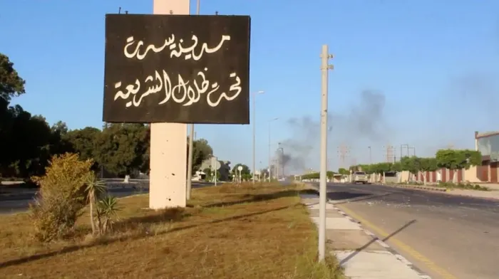 Framed Print : Still image of an Arabic sign with smoke rising in background as forces aligned with Framed Print : Still image of an Arabic sign with smoke rising in background as forces aligned with