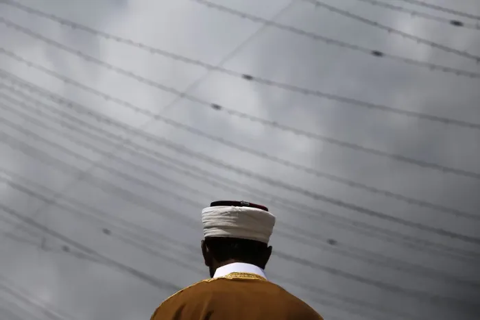 Framed Print : An imam leads Eid al-Fitr services as Muslim worshippers pray in the Queens borough of