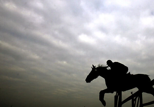 An Indian horse rider jumps an obstacle during a horse show in Kolkata