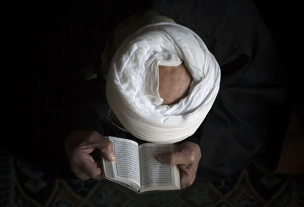 An Iranian cleric prays during Friday prayers in Tehran