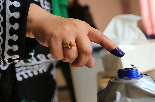 An Iraqi womans finger is seen stained with ink at a polling station during the