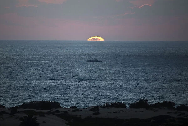 Israeli naval vessel sails near Kibbutz Zikim, just north of the Gaza Strip