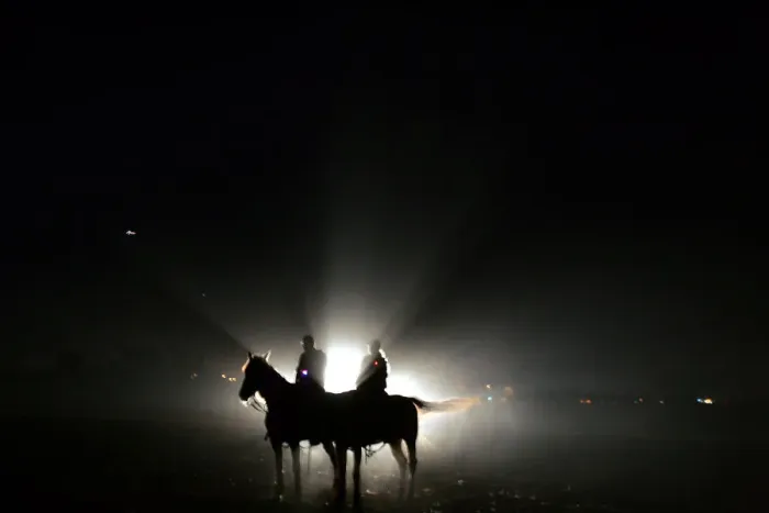 Framed Print : Israeli policemen sit on their horses in a standby position on the field outside