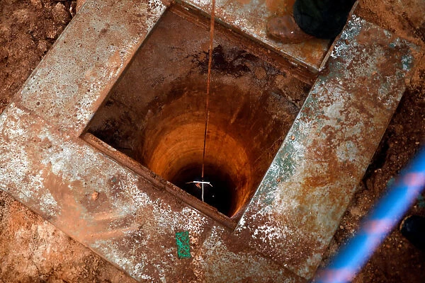 An Israeli soldier lowers a camera down an Israeli-dug hole into a cross-border tunnel