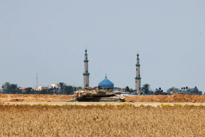 Framed Print : An Israeli tank is seen on the Israeli side of the border fence between Israel Framed Print : An Israeli tank is seen on the Israeli side of the border fence between Israel