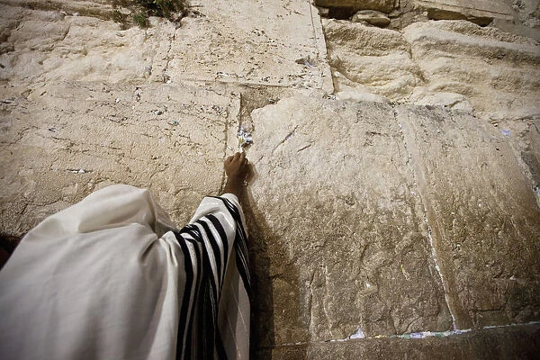 A Jewish worshipper prays at the Western Wall during prayers marking Tisha B Av