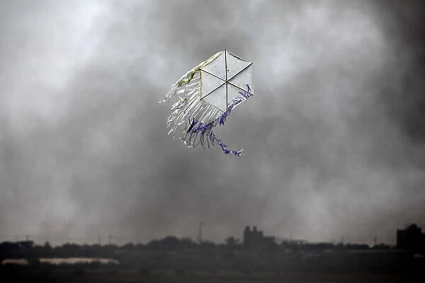 A kite flies over the border in an area where kites and balloons have caused blazes