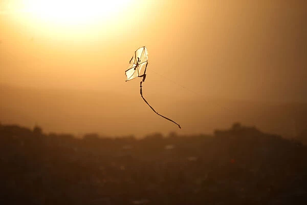 A kite flies over a neighbourhood in Port-au-Prince