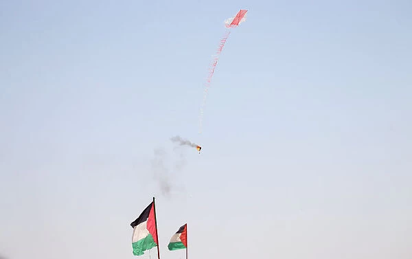 Kite loaded with a flammable material is flown by Palestinian demonstrators to be thrown