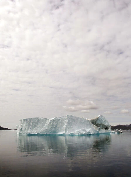 A large iceberg floats in a fjord near the south Greenland town of Narsaq