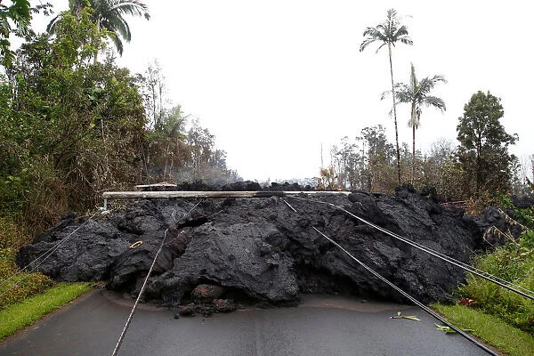 Lava and downed power lines block a road in the Leilani Estates subdivision during