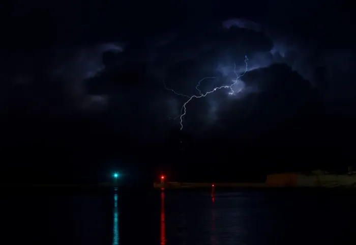 Framed Print : A lightning storm is seen beyond the entrance to Vallettas Grand Harbour Framed Print : A lightning storm is seen beyond the entrance to Vallettas Grand Harbour