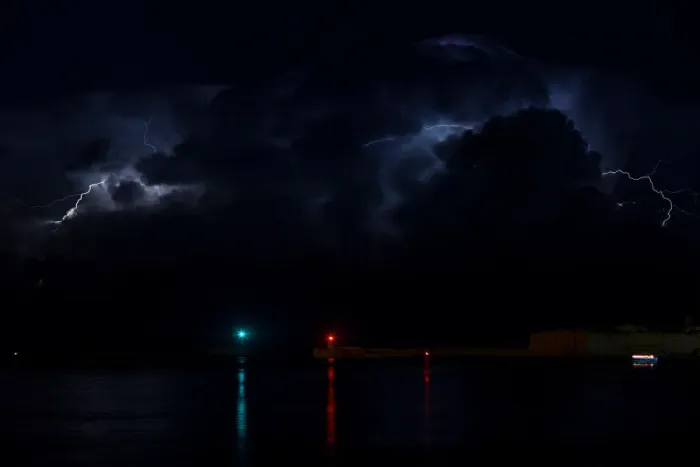Framed Print : A lightning storm is seen beyond the entrance to Vallettas Grand Harbour Framed Print : A lightning storm is seen beyond the entrance to Vallettas Grand Harbour