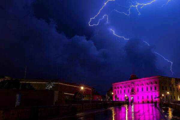 Lightning streaks are seen during a storm over the Auberge de Castille, the office