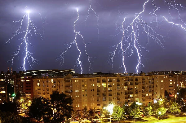 Lightning strikes over buildings during a thunderstorm in Belgrade