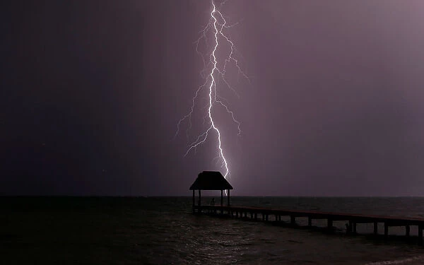 Lightning strikes the Caribbean as a thunderstorm passes Tankah Bay, near Tulum, southern