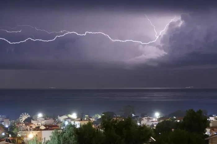 Framed Print : Lightnings strike in the sea off the shore of Artemida