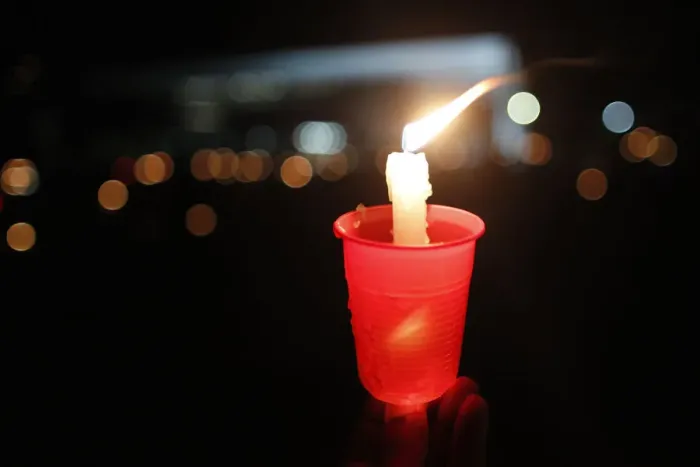 Framed Print : A lit candle is seen as Catholics keep vigil in front of Brazils Supreme Court, in Framed Print : A lit candle is seen as Catholics keep vigil in front of Brazils Supreme Court, in