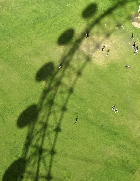 The London Eye casts a shadow on Jubilee Gardens in London