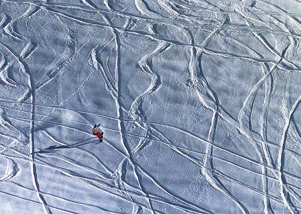 A lone snowboarder slides down a hill near the ski resort of Arosa