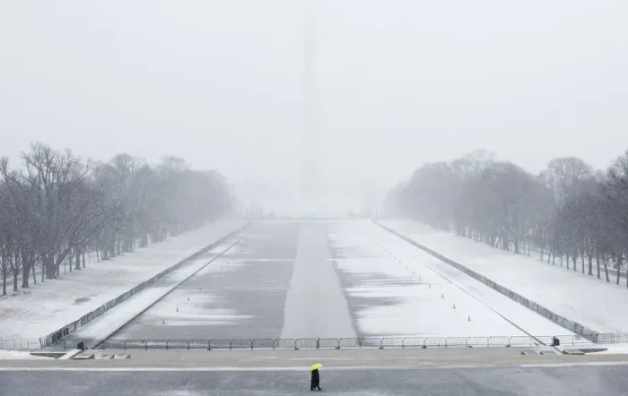 Framed Print : A lone tourist walks on the National Mall near the Lincoln Memorial during a snow storm Framed Print : A lone tourist walks on the National Mall near the Lincoln Memorial during a snow storm