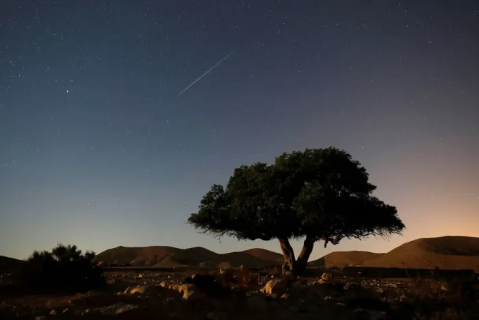 Framed Print : A long exposure shows a meteor streaking across the sky in the early morning during