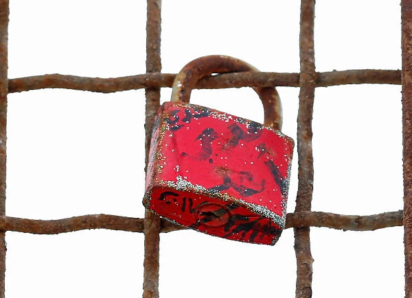 A love lock is seen attached to a metal fence near the canal of Port Said