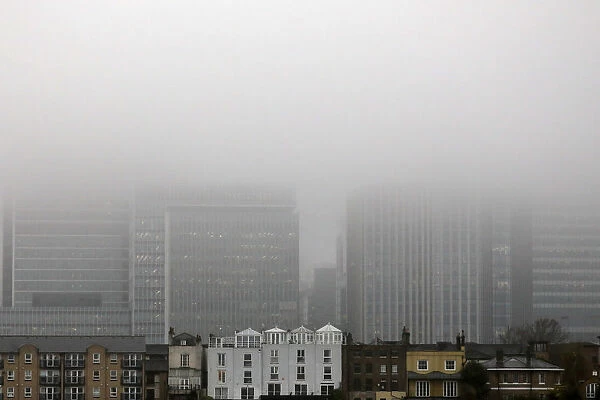 A low fog engulfs the skyscrapers of the financial district of Canary Wharf