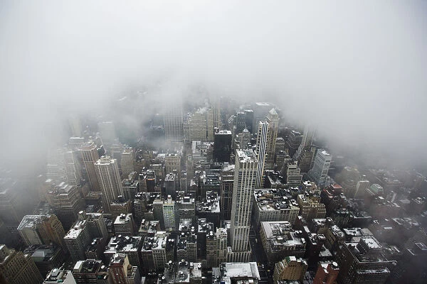 Low lying clouds from a snowstorm obscure the skyline of New York